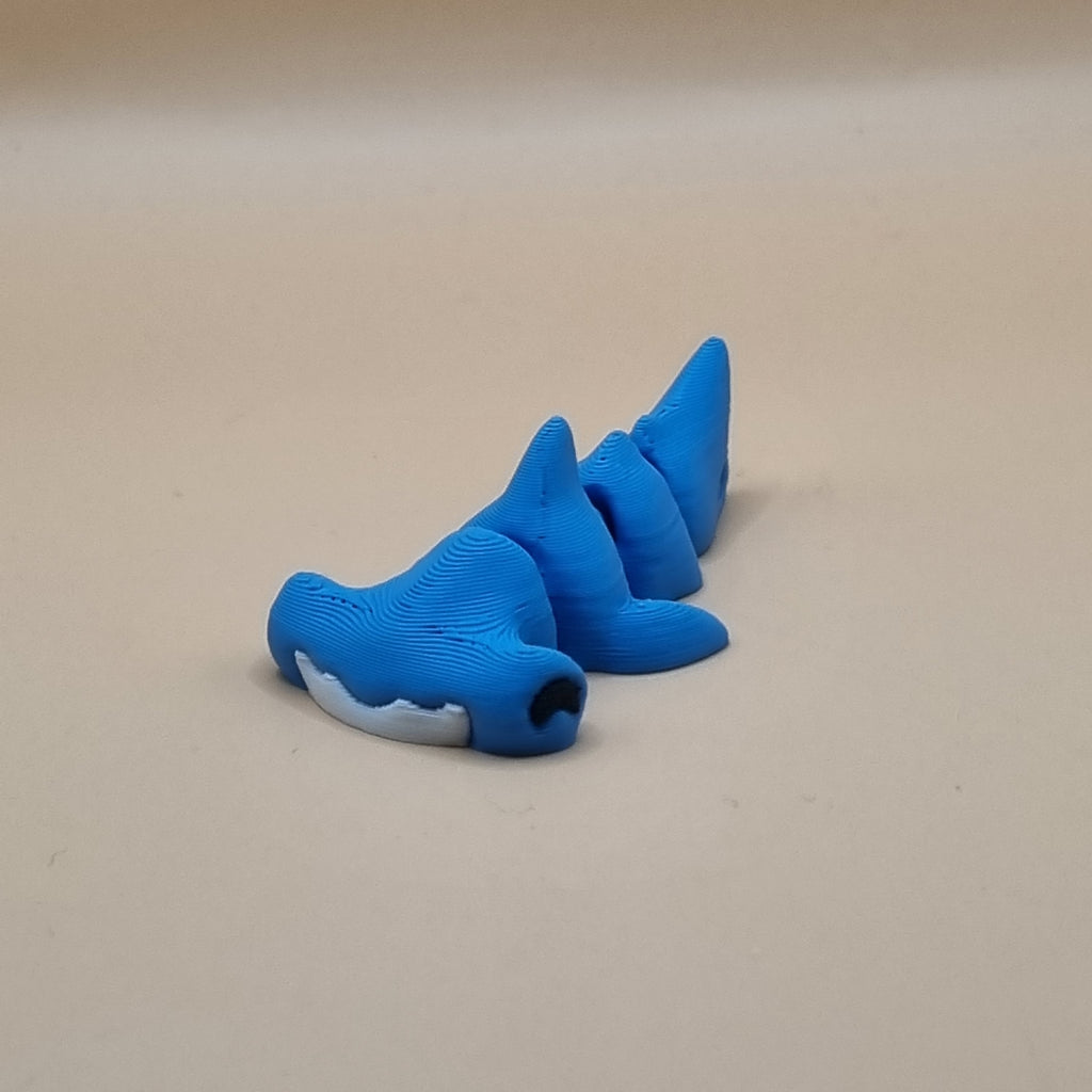 Blue shark-shaped object on a beige background
