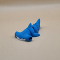 Blue shark-shaped object on a beige background